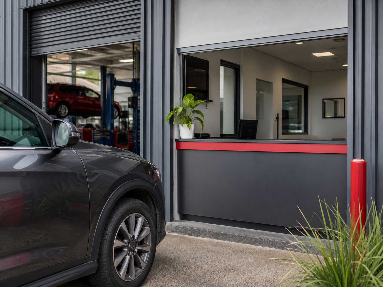 Generated placeholder image of a modest automotive workshop entrance and reception area.